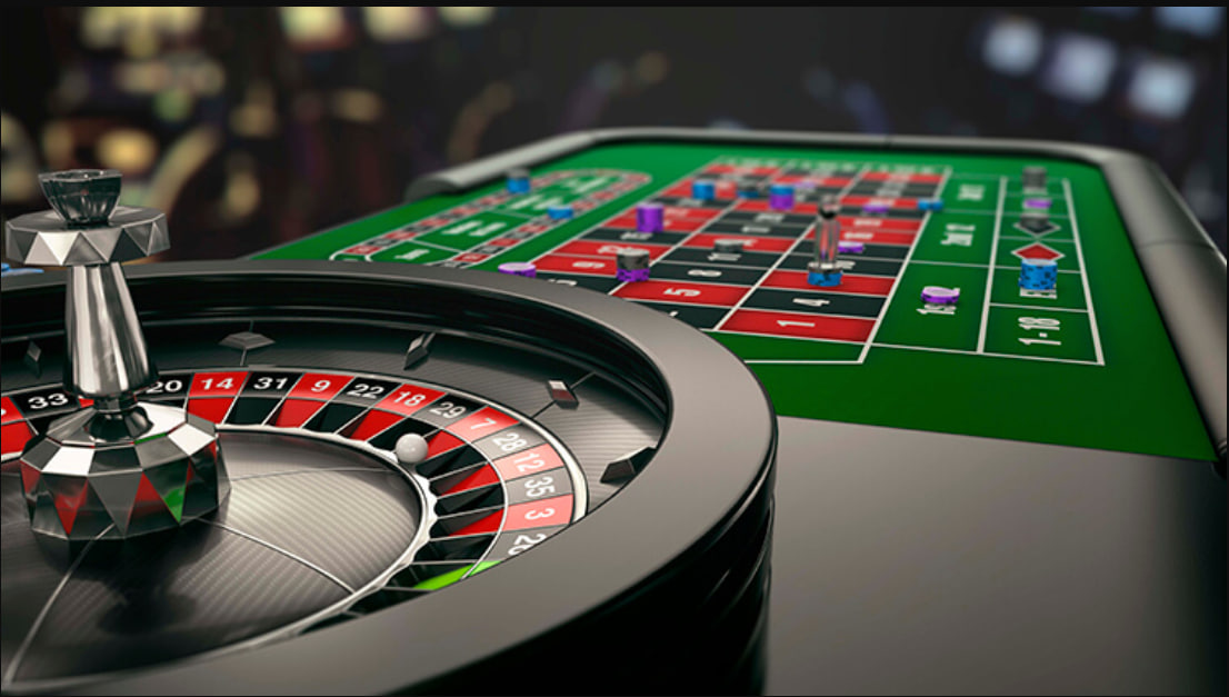 A person happily playing real money casino games on their laptop.